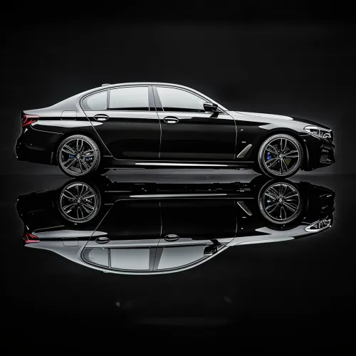 Modern black sedan with reflection on the glossy surface