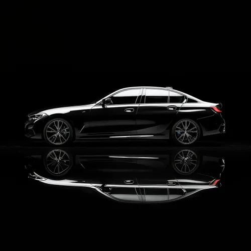 Black car with striking reflection on a black background