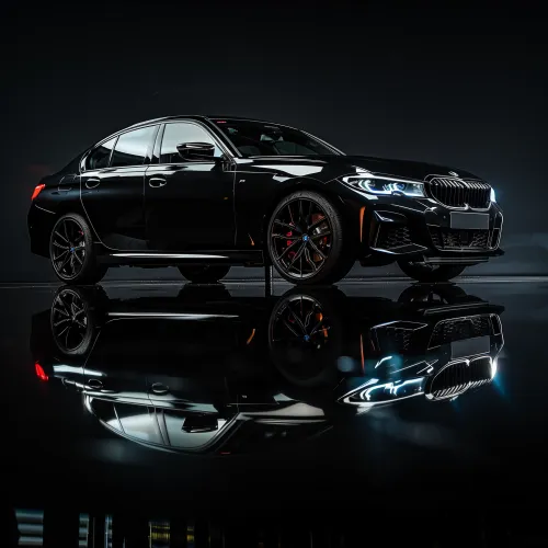 Modern black sedan with reflection on a glass surface