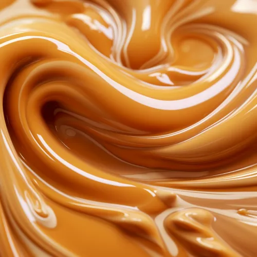 Primer plano de una masa cremosa suave y brillante de color caramelo