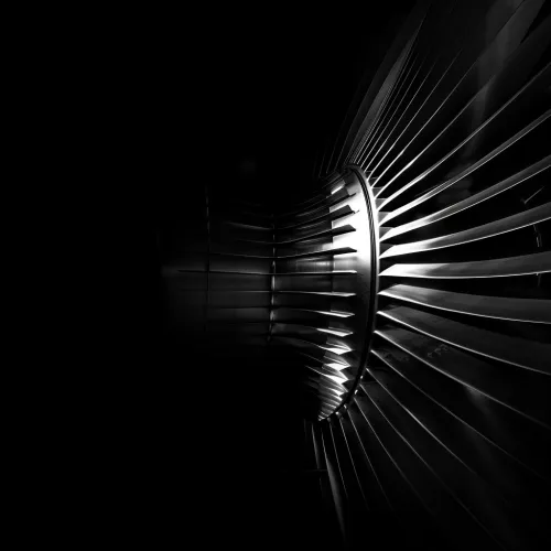 Primer plano de las palas metálicas de la turbina sobre un fondo negro