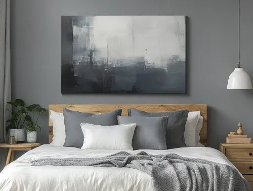 Dormitorio en tonos grises con una obra de arte abstracta en el interior