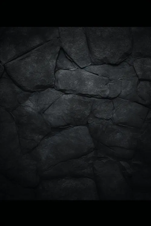 Detailed texture of dark stone with uneven edges and cracks