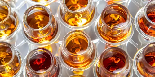 Super close-up image of glasses with various dark and golden beverages