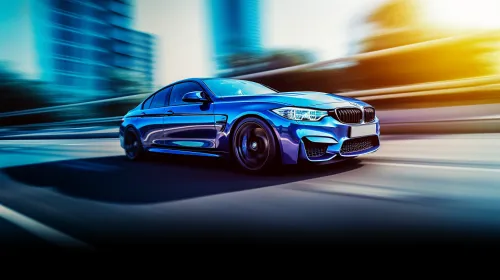 Blue sports car BMW driving on a road in an urban landscape