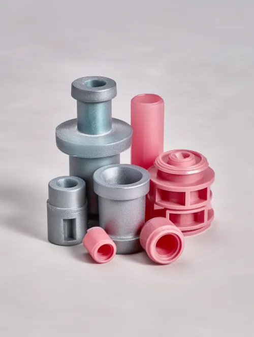 A set of plastic parts of various shapes and colors on a neutral background