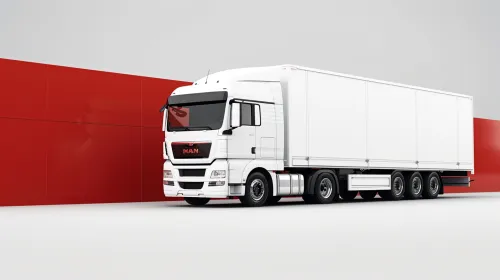 A white MAN truck stands against a bright red wall in a minimalist design