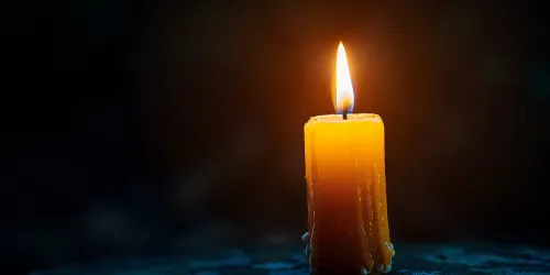Candle with a Bright Flame, Burning Against the Darkness