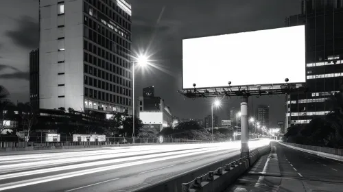 Illuminated billboard against the backdrop of urban architecture at night