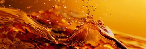 Water texture with droplets in warm golden tones