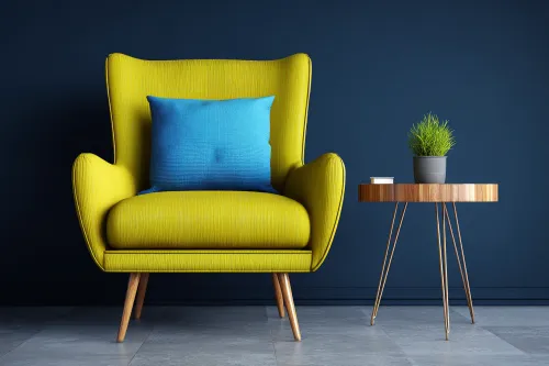 Yellow armchair with blue cushion next to a wooden table
