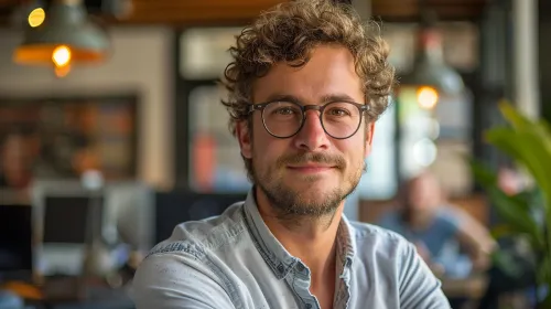 Young man with curly hair in a cozy office atmosphere