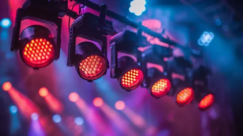 Spotlights illuminate the stage with colorful light effects at a concert