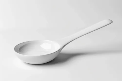 Elegant white spoon placed on a neutral surface
