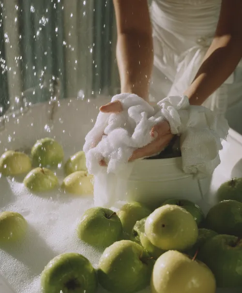 The process of washing green apples using soap bubbles