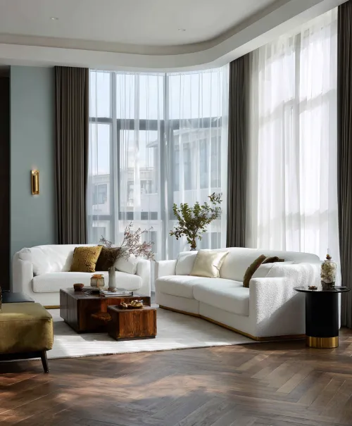 Stylish living room with white sofas and wooden tables