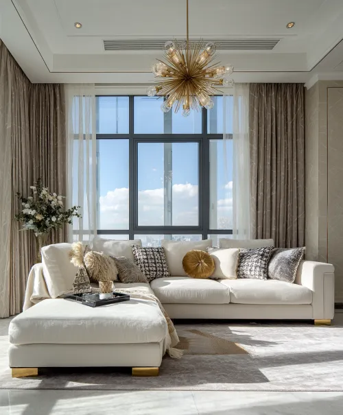 Living room with a cozy sofa and luxurious chandelier in a modern style