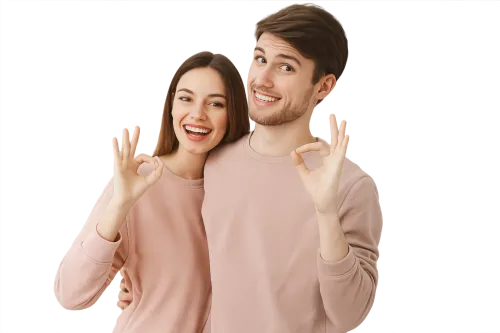 Young couple in front of a black background showing an 'OK' gesture with smiles