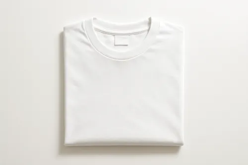 Simple white t-shirt neatly folded on a light background