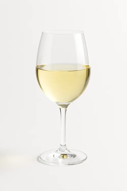 Clear glass of white wine filled halfway
