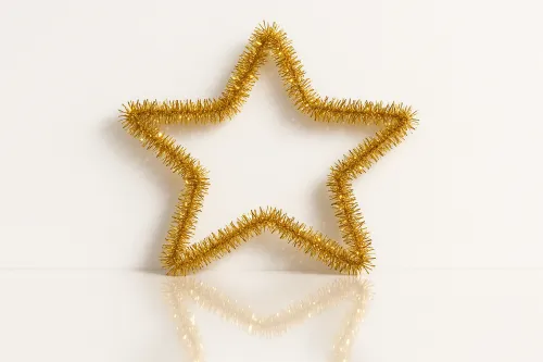 Блестящая золотая звезда, окрашенная в яркий цвет, на белом фоне