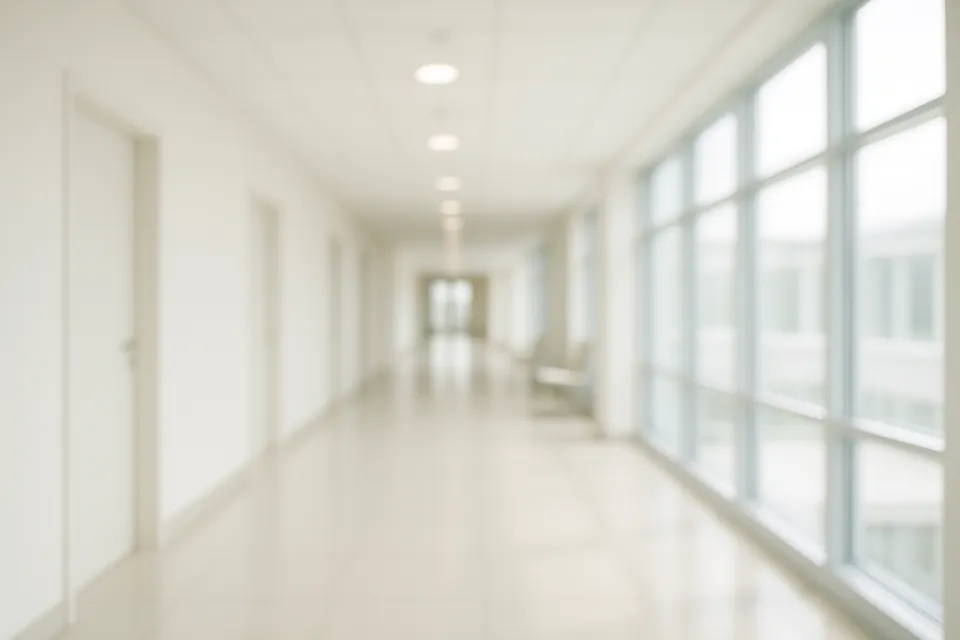Bright corridor with blurred windows and doors on both sides