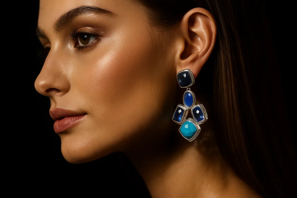 Woman in profile wearing large earrings made of colorful stones