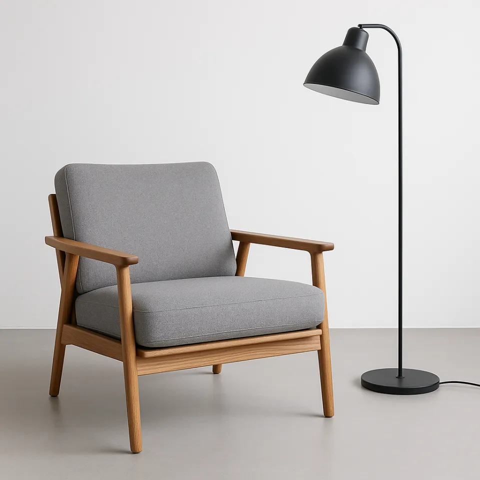 Comfortable gray armchair with wooden armrests and elegant lamp