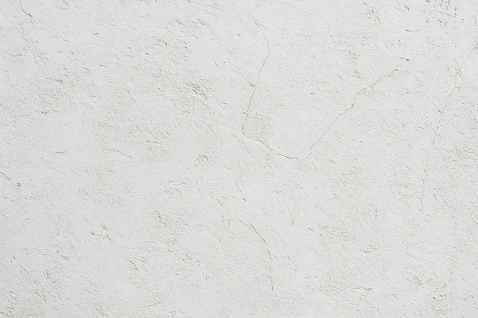 White wall with texture and cracks, creating an interesting visual effect
