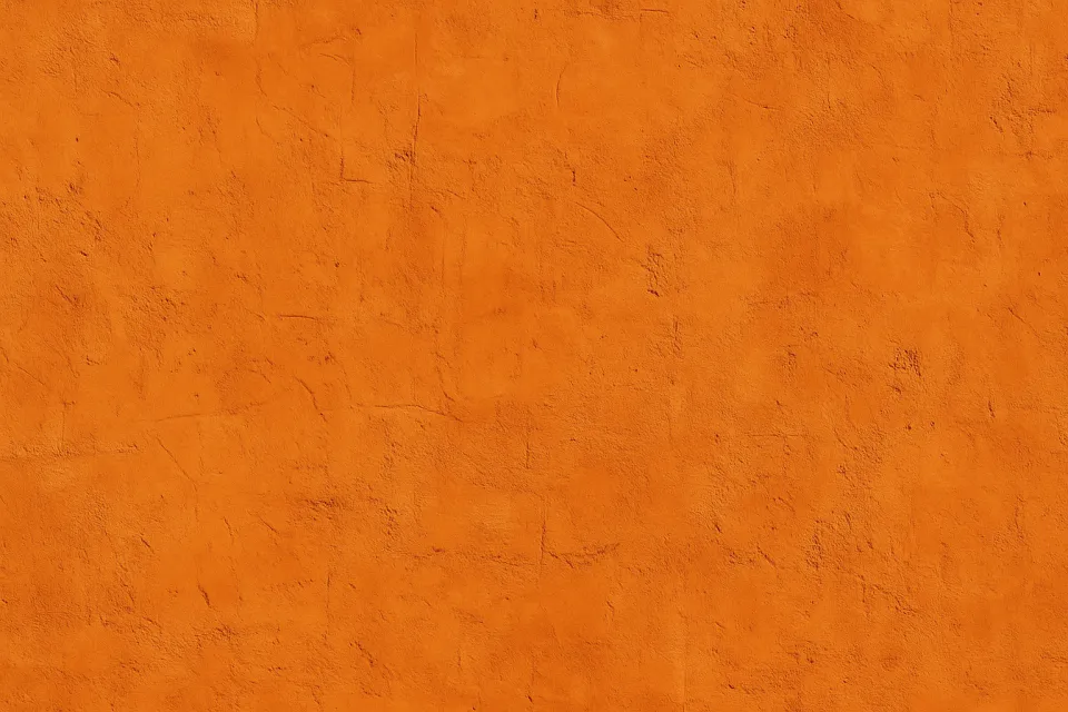 Surface of a wall with an orange plaster texture