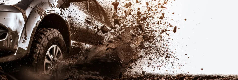 Off-roader splashing mud on unstable ground