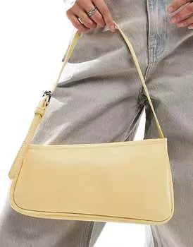 ASOS DESIGN – Асимметричная сумка через плечо молочно-желтого цвета с пряжкой