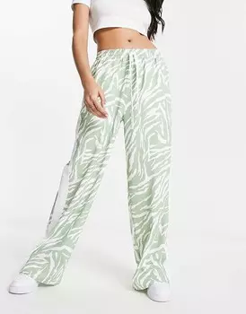 ASOS DESIGN – Шалфейно-зеленые брюки без застежки с контрастной вставкой и животным принтом