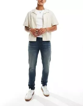 ASOS DESIGN – темно-синие джинсы скинни с желтым эффектом размытия