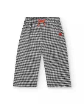 Черно-белые брюки в мелкую клетку для девочки с красным бантом Tuc tuc