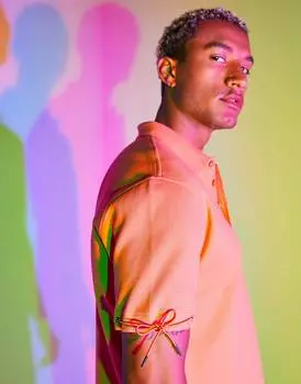 Оранжевое свободное вафельное поло с завязками ASOS DESIGN