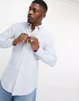 Polo Ralph Lauren — узкая оксфордская рубашка в сине-белую полоску со знаменитым логотипом