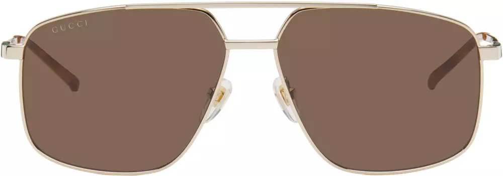 Солнцезащитные очки в золотой оправе Navigator Gucci