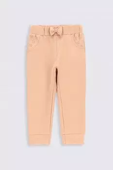 Тренировочные брюки Coccodrillo розовая однотонная с бантом в РЕГУЛЯРНОМ моде