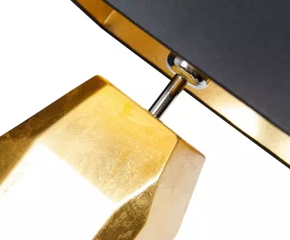 Настольная лампа золотого цвета с черным абажуром