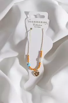 Браслет золотого цвета с подвеской в виде сердца из камня и циркона