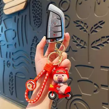 Брелок-подвеска в виде мультяшной капибары на велосипеде, симпатичное забавное животное, кукла, брелок для рюкзака, украшения, аксессуары, подарки розовый