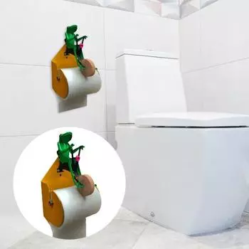 Держатель для туалетной бумаги. Милый дизайн в виде лягушки. Легко устанавливается. Лягушка, ездящая на одноколесном велосипеде. Стена.
