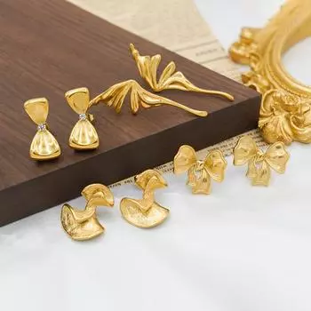 Fashion geometric bow titanium steel earrings 18k gold temperament niche design exaggerated earrings