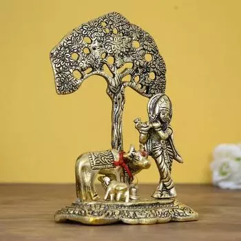 Господь Кришна играет на флейте под деревом с золотой коровой и теленком