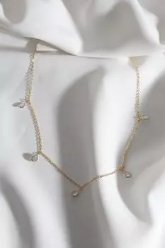 Колье золотого цвета с рядами круглых камней