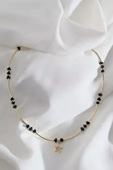 Ожерелье золотого цвета с подвеской в виде звезды из черной бусины и детали трубы
