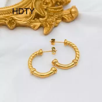Retro stainless steel twist earrings plated with 18k gold, simple niche design, fashionable and versatile earrings. золотой
