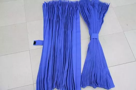 These pleated truck curtains for naps are royal blue and feature blackout They measure 240cm wide x 90cm long The round design encloses the blocking
