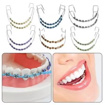 Временное украшение зубов металлической проволокой Брекеты Ортодонтические лигатуры Ортодонты объясняют Реквизиты для практики студентов-стоматологов жёлтый